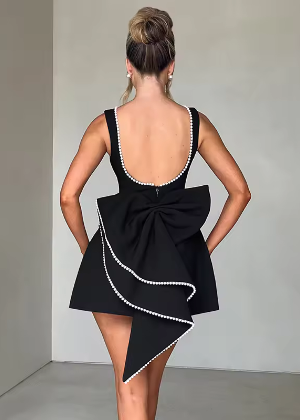 Sleeveless mini dress with pearl-style trim and back bow for women | Bellarose